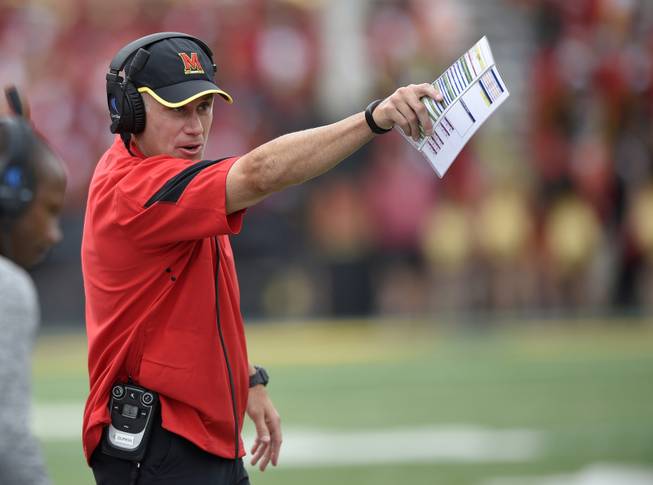 In this Sept. 3, 2016, file photo, Maryland head coach DJ Durkin gestures during the second half of an NCAA football game against Howard in College Park, Md. Maryland first-year coach Durkin must improve his own defense if the Terrapins are to have a chance to upset the second-ranked Wolverines on Nov. 5.