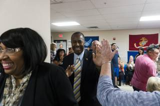 Ben Carson high-fives a support as he enters the building during a rally for Presidential Candidate Donald Trump at Trump-Pence Nevada Headquarters, Saturday, Nov. 5, 2016.