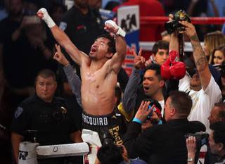 Manny Pacquiao of the Philippines celebrates after defeating WBO welterweight champion Jessie Vargas of Las Vegas at the Thomas & Mack Center Saturday, Nov. 5, 2016.
