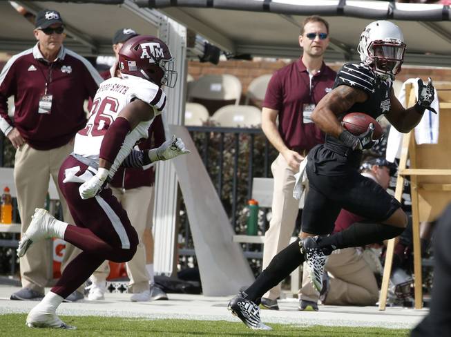 Mississippi State wide receiver Fred Ross (8) looks back as he runs away from Texas A&M defensive back DeShawn Capers-Smith (26) for a 60-yard touchdown pass reception in the first half of an NCAA college football game in Starkville, Miss., Saturday, Nov. 5, 2016. 
