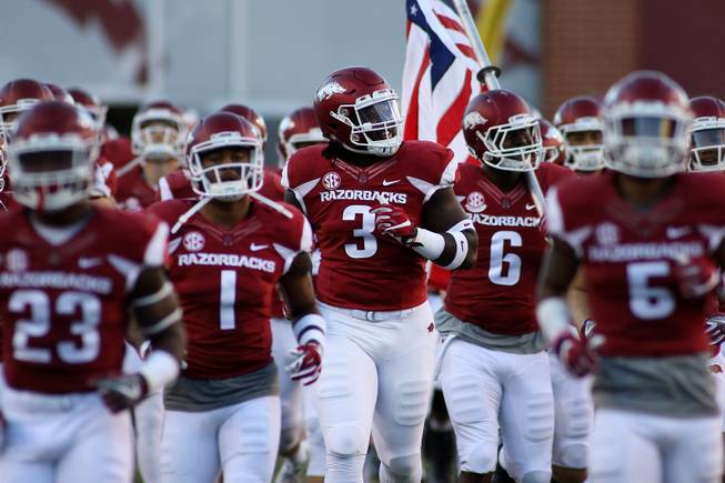 Arkansas' McTelvin Agim smiles as he runs out with the team before the start of an NCAA college football game against Alabama Saturday, Oct. 8, 2016 in Fayetteville, Ark. Alabama beat Arkansas 49-30. 
