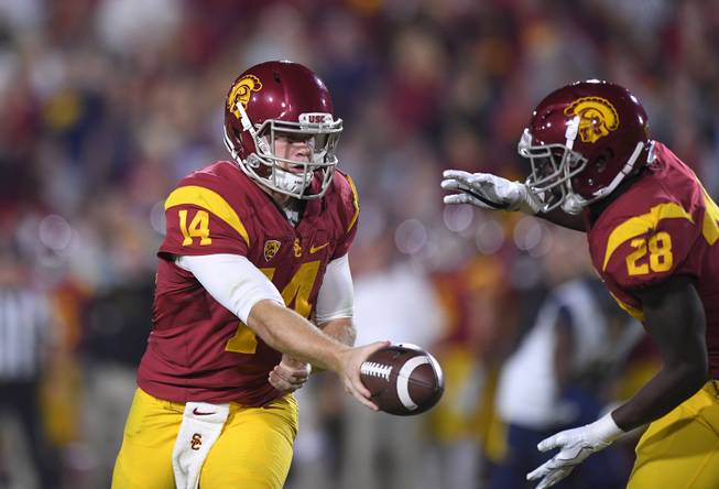 Southern California quarterback Sam Darnold hands off to running back Aca'Cedric Ware  during the first half of an NCAA college football game against California, Thursday, Oct. 27, 2016, in Los Angeles. (AP Photo/Mark J. Terrill)