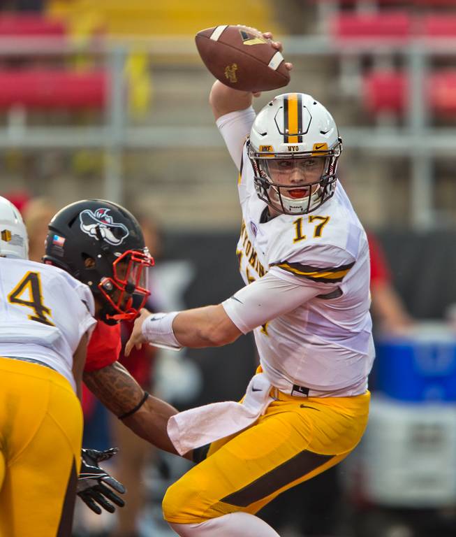 Wyoming QB Josh Allen (17) is nearly sacked in his own end zone by UNLV defenders late during their game at Sam Boyd Stadium on Saturday, Nov. 12, 2016.