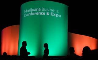 Audience members walk along the front of a stage after listening to keynote speakers during the 5th Annual Marijuana Business Conference & Expo at the Rio Hotel and Casino, Wednesday, Nov. 16, 2016.