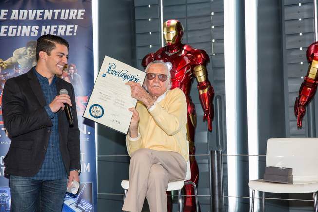Marvel Comics legend Stan Lee holds up the official proclamation of "Stan Lee Day" at Marvel's Avengers S.T.A.T.I.O.N. during a promo for Lee's "Respect" lapel pin, signifying unity among Americans, Friday Nov. 18, 2016.