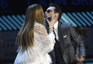 Jennifer Lopez, left, kisses Marc Anthony after presenting the person of the year award at the 17th annual Latin Grammy Awards at the T-Mobile Arena on Thursday, Nov. 17, 2016, in Las Vegas. (Photo by Chris Pizzello/Invision/AP)