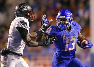 Boise State running back Jeremy McNichols (13) runs the ball against UNLV defensive back Darius Mouton (21) during the second half of an NCAA college football game in Boise, Idaho, Friday, Nov. 18, 2016. Boise State won 42-25. (AP Photo/Otto Kitsinger)