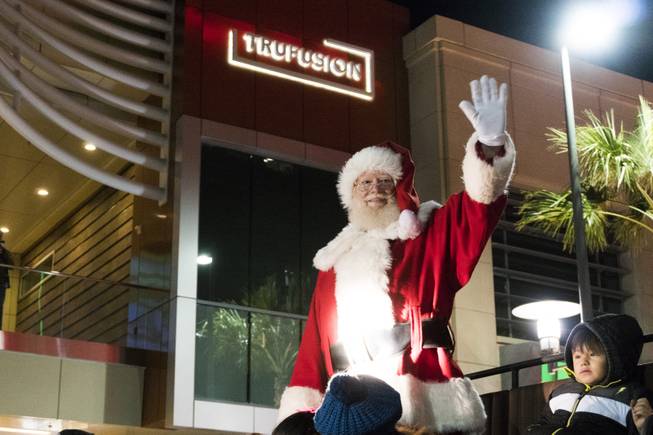 Santa Claus waves at the crowd during the Downtown Summerlin Holiday Parade which included the tree lighting celebration, Friday, Nov. 18, 2016.