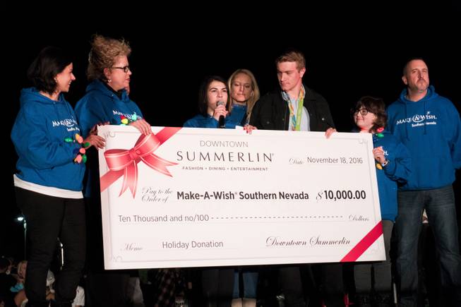 BMX Olympic gold medal winner Connor Fields presents a $10,000.00 check to the Make-A-Wish Foundation on behalf of Downtown Summerlin during the Downtown Summerlin Holiday Parade which included the tree lighting celebration, Friday, Nov. 18, 2016.
