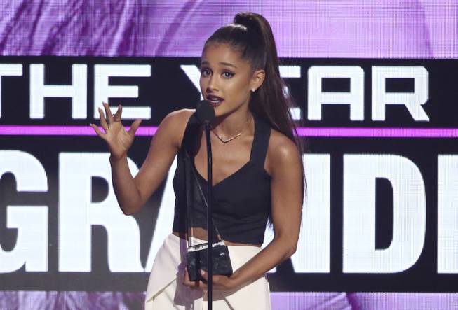 Ariana Grande accepts the award for artist of the year at the American Music Awards at the Microsoft Theater on Sunday, Nov. 20, 2016, in Los Angeles.