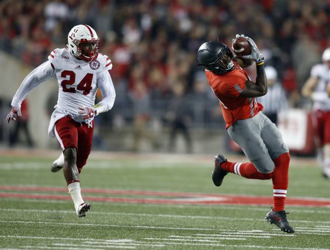 Ohio State running back Curtis Samuel, right, makes a catch in front of Nebraska safety Aaron Williams to score a touchdown during the second half of an NCAA college football game Saturday, Nov. 5, 2016, in Columbus, Ohio. Ohio State won 62-3. 