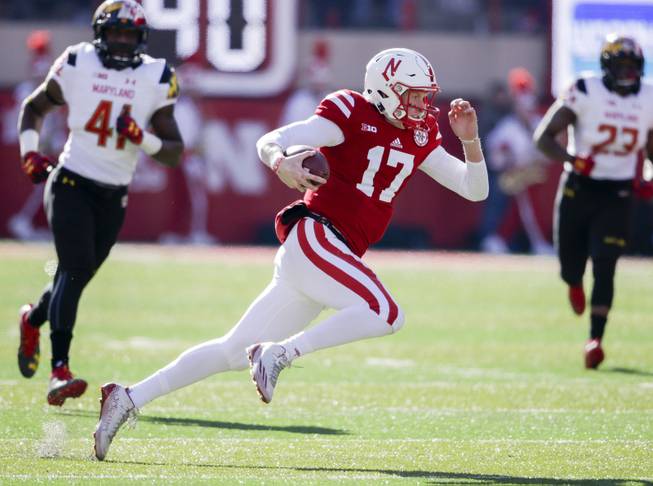 Nebraska quarterback Ryker Fyfe (17) carries the ball away from Maryland defensive lineman Jesse Aniebonam (41) and linebacker Jermaine Carter (23) during the first half of an NCAA college football game in Lincoln, Neb., Saturday, Nov. 19, 2016. 