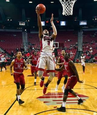 UNLV forward Tyrell Green (3) elevates to the basket over WKU defenders during their game at the Thomas & Mack Center on Saturday, Nov. 26, 2016.