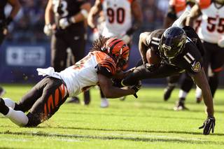 Baltimore Ravens wide receiver Kamar Aiken (11) is stopped by Cincinnati Bengals cornerback Adam Jones (24) during the first half of an NFL football game in Baltimore, Sunday, Nov. 27, 2016. (AP Photo/Gail Burton)