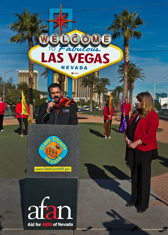 Antioco Carillo with AID for AIDS of Nevada (AFAN) speaks beside County Commissioner Marilyn Kirkpatrick as the 39th World AIDS Day events begin and will take place throughout the day with this opening ceremony by at the Welcome to Fabulous Las Vegas sign and later to be lit up red on Wednesday, Dec. 1, 2016.