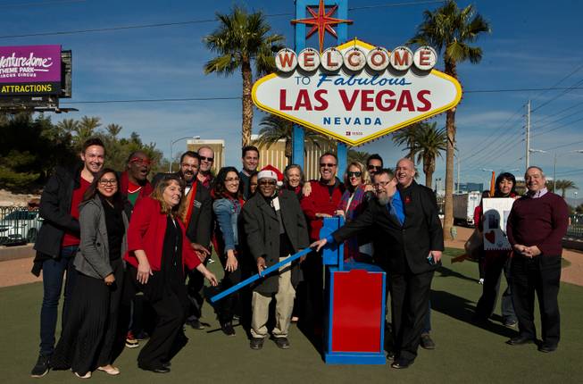 Supporters for AID for AIDS of Nevada (AFAN) and others gather to throw a ceremonial switch as the 39th World AIDS Day events begin and will take place throughout the day in the city and here by at the Welcome to Fabulous Las Vegas sign, later to be lit up red on Wednesday, Dec. 1, 2016.