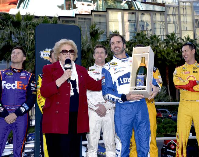 Las Vegas Mayor Carolyn G. Goodman presents Jimmie Johnson with an inscribed bottle of champagne and his photo congratulating him for 7th NASCAR Sprint Championship.  NASCARs Sprint Cup Series Champions shut down the Las Vegas Strip on Dec. 1 to take a victory lap and do burnouts on the famed boulevard as part of Champions Week in Las Vegas. Thursday, December 1, 2016.