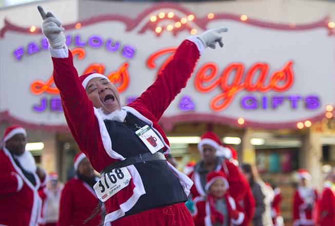 Antoinette Tolvon dances near the Third Street Stage before the 12th annual Las Vegas Great Santa Run in downtown Las Vegas Saturday, Dec. 3, 2016. The fundraiser supports Opportunity Village, a charitable organization that supports people with intellectual disabilities.