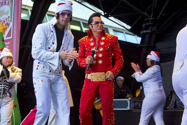 Elvis Presley tribute artist Jesse Garon, center, performs with members of the OV Elvi dance troupe perform during the 12th annual Las Vegas Great Santa Run in downtown Las Vegas Saturday, Dec. 3, 2016. The fundraiser supports Opportunity Village, a charitable organization that supports people with intellectual disabilities.