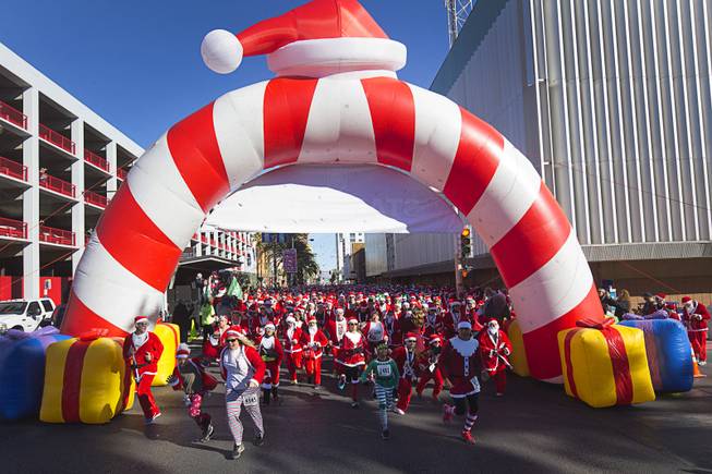 Runners head southbound on Las Vegas Boulevard at the start of the 12th annual Las Vegas Great Santa Run in downtown Las Vegas Saturday, Dec. 3, 2016. The fundraiser supports Opportunity Village, a charitable organization that supports people with intellectual disabilities.
