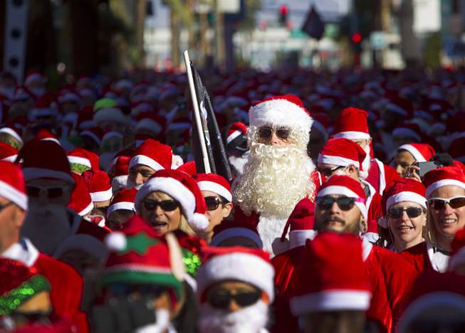 Runners wait on Las Vegas Boulevard at the start of the 12th annual Las Vegas Great Santa Run in downtown Las Vegas Saturday, Dec. 3, 2016. The fundraiser supports Opportunity Village, a charitable organization that supports people with intellectual disabilities.