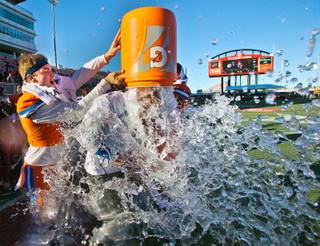 Bishop Gorman QB Tate Martell (18) joins teammates in dunking ice water on head coach Kenny Sanchez as the game winds down versus Liberty during their high school football state championship game at Sam Boyd Stadium on Saturday, Dec. 3, 2016.