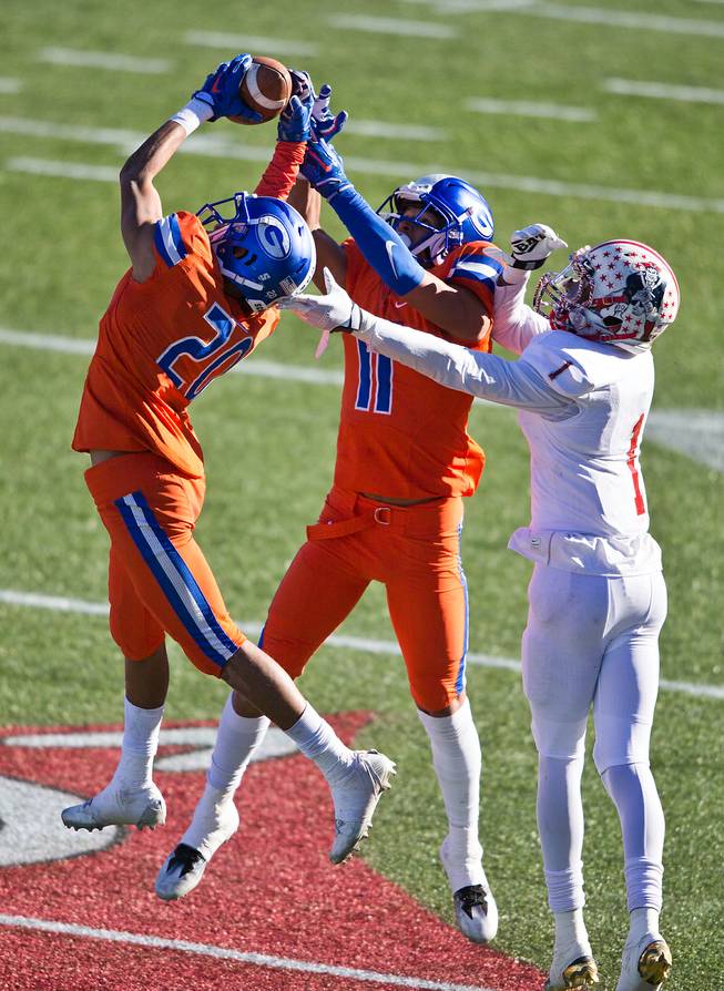 Bishop Gorman's Greg Oliver (20) intercepts a pass with the help of teammate Bubba Bolden (11) intended for Liberty's Marquez Powell (1) during their high school football state championship game at Sam Boyd Stadium on Saturday, Dec. 3, 2016.