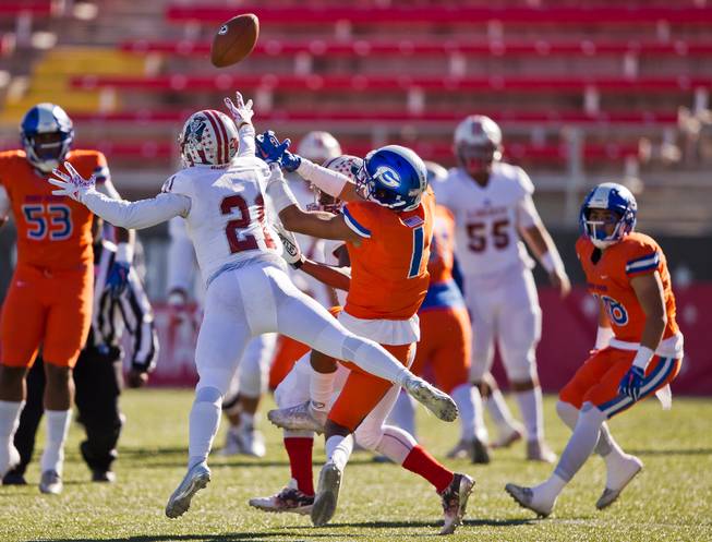 Liberty's Darion Acohido (21) has the ball deflected by Bishop Gorman's Greg Francis (1) which results in an interception during their high school football state championship game at Sam Boyd Stadium on Saturday, Dec. 3, 2016.