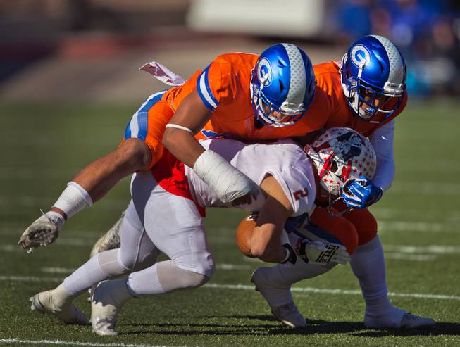 Liberty's Ethan Dedeaux (2) is driven down by Bishop Gorman defenders during their high school football state championship game at Sam Boyd Stadium on Saturday, Dec. 3, 2016.