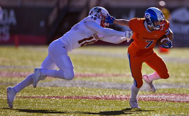 Bishop Gorman's Biaggio Walsh (7) shrugs off Liberty's Damahny Whittle (18) for a run into the end zone during their high school football state championship game at Sam Boyd Stadium on Saturday, Dec. 3, 2016.