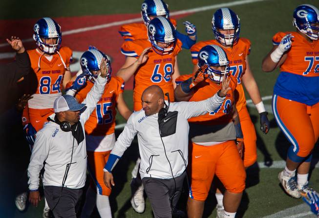 Bishop Gorman head coach Kenny Sanchez joins his team in signaling the fourth quarter versus Liberty during their high school football state championship game at Sam Boyd Stadium on Saturday, Dec. 3, 2016.