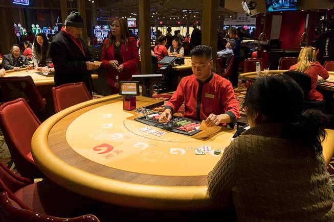 A gambler plays blackjack during Lucky Dragons grand opening celebration, Saturday, Dec. 3, 2016.