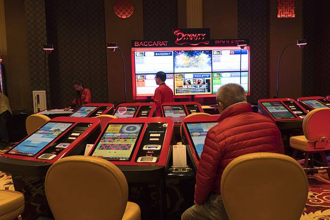 A gambler sits at a digital Baccarat Roulette game during Lucky Dragons grand opening celebration, Saturday, Dec. 3, 2016.