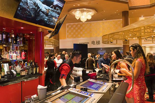 A bartender fills drink orders for gamblers at Lucky Dragon during the boutique casinos grand opening celebration, Saturday, Dec. 3, 2016.