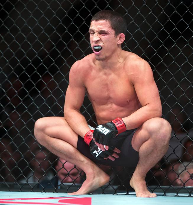 Flyweight Joseph Benavidez takes a momentary breather after a kick to the groin from Henry Cejudo during their Ultimate Fighter 24 Finale fight at The Palms on Saturday, Dec. 3, 2016.