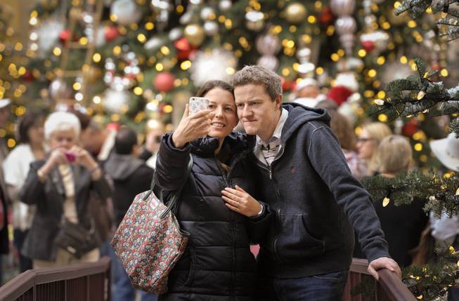 Melanie and William Cosgrave of Dublin, Ireland snap a photo in the annual holiday display at the Bellagio Conservatory and Botanical Gardens in Las Vegas on Monday, Dec. 5, 2016. The Bellagio horticulture staff has assembled this year's display with 34,000 flowers, 750 plants and shrubs, and 25 trees to transform the 14,000-square-foot floral playground into a showcase of the distinctive sights and colors of the season.