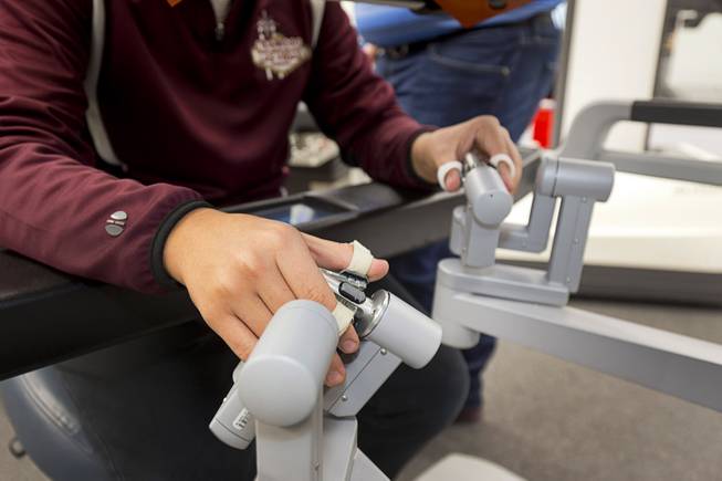 Sophomore Dustan Wile tries out Intuitive's da Vinci Xi robotic surgical system at the Cimarron-Memorial High School engineering lab Tuesday, Dec. 6, 2016. MountainView Hospital and Intuitive Surgical, Inc. partnered in the event to teach students about careers in robotics, engineering and medicine.