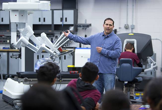 Dr. Brian Citro, a local surgeon, talks about using Intuitive's da Vinci Xi robotic surgical system at the Cimarron-Memorial High School engineering lab Tuesday, Dec. 6, 2016. MountainView Hospital and Intuitive Surgical, Inc. partnered in the event to teach students about careers in robotics, engineering and medicine.
