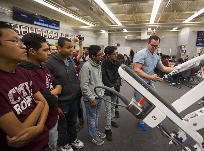 Chance Larsen, a senior clinical sales representative at Intuitive Surgical, talks about the robotic arms of Intuitive's da Vinci Xi robotic surgical system at the Cimarron-Memorial High School engineering lab Tuesday, Dec. 6, 2016. MountainView Hospital and Intuitive Surgical, Inc. partnered in the event to teach students about careers in robotics, engineering and medicine.