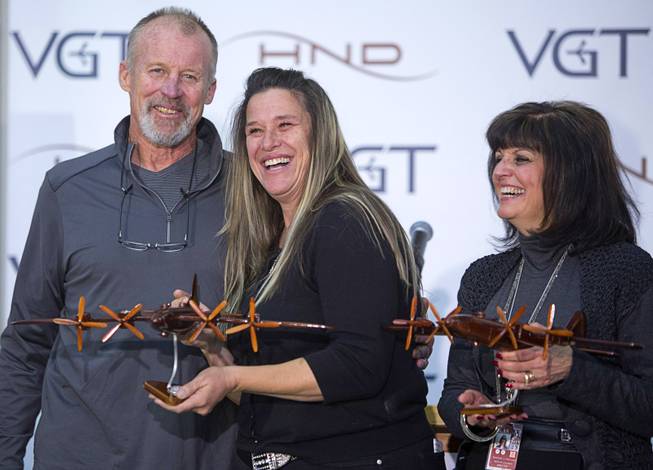 Robin Sendlein, left, and Darcy Wellington, grandchildren of airport founders John and Florence Murphy, and Rosemary Vassiliadis pose with wooden models of B-29 bombers during a ceremony celebrating the 75th anniversary of the North Las Vegas Airport Wednesday, Dec. 7, 2016. The airport, originally called Sky Haven Airport when it opened in 1941, will host an aviation open house on Saturday, Dec. 10, from 9 am. to 3 pm.