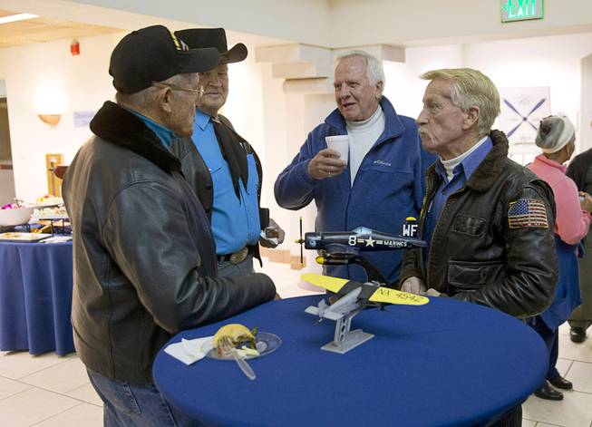 Pilots gather around a table following a ceremony celebrating the 75th anniversary of the North Las Vegas Airport Wednesday, Dec. 7, 2016. The airport, originally called Sky Haven Airport when it opened in 1941, will host an aviation open house on Saturday, Dec. 10, from 9 am. to 3 pm.