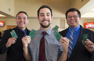 Engineering students (L-R) Jorge Caballero, Samuel Villanueva, and Alvaro Orduna Dominguez poses with wireless receivers and transmitters during a UNLV Senior Design showcase at UNLV Wednesday, Dec. 7, 2016. The devices are designed to untether cardiac patients during treadmill stress tests, they said.