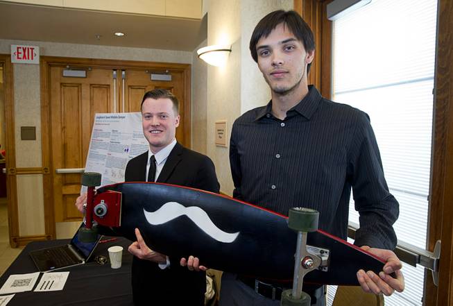 UNLV engineering students Craig Anderson, left, and Trevor Hunt show off a dampening system on the front of a skateboard during a UNLV Senior Design showcase at UNLV Wednesday, Dec. 7, 2016. The system helps reduce wobble at high speeds, they said.
