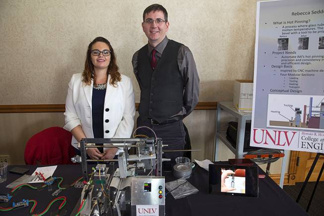 UNLV engineering students Rebecca Seddon and Cory Nichols pose by an automated hot pinning machine prototype during a UNLV Senior Design showcase at UNLV Wednesday, Dec. 7, 2016. Hot pinning involves heating the edges of the tube and then applying an appropriate bevel.