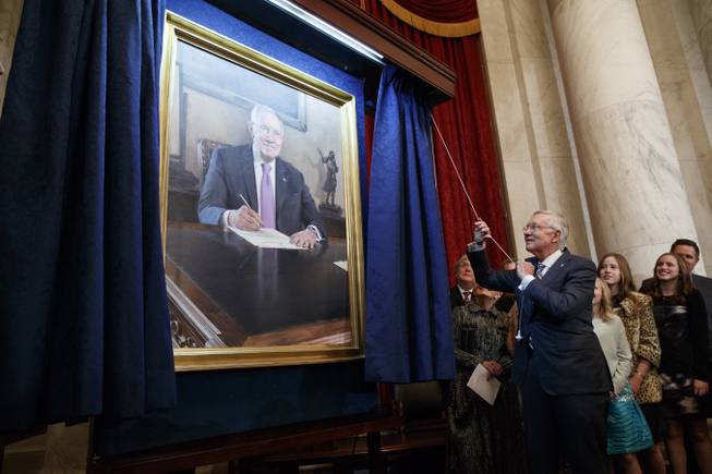 Sen. Harry Reid, D-Nev., unveils his portrait during a ceremony to honor his service in the Senate, on Capitol Hill, Thursday, Dec. 8, 2016, in Washington.