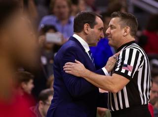 Duke head coach Mike Krzyzewski greets an official as they face UNLV during their game at the T-Mobile Arena on Saturday, Dec. 10, 2016.