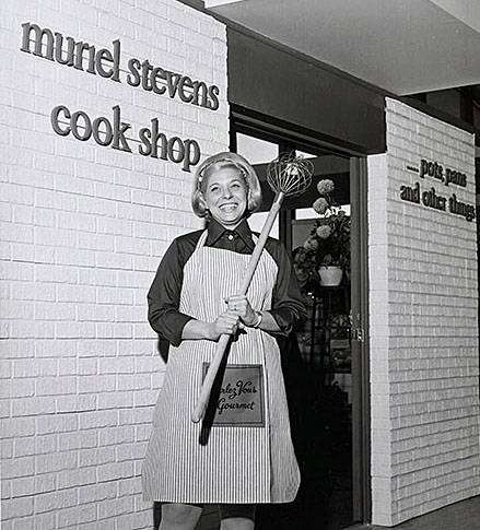Muriel Stevens is shown in front of her cook shop, circa 1975.