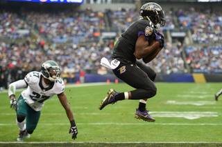 Baltimore Ravens wide receiver Kamar Aiken (11) pulls in a touchdown pass as Philadelphia Eagles strong safety Malcolm Jenkins (27) looks on during the first half of an NFL football game in Baltimore, Sunday, Dec. 18, 2016. (AP Photo/Nick Wass)