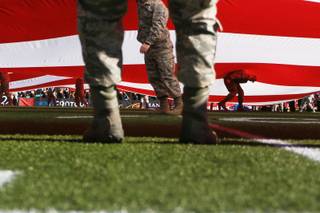 Airmen from Nellis Air Force Base hold up the U.S. flag before the Las Vegas Bowl Saturday, Dec. 16, 2016, at Sam Boyd Stadium. San Diego State won the game 34-10.