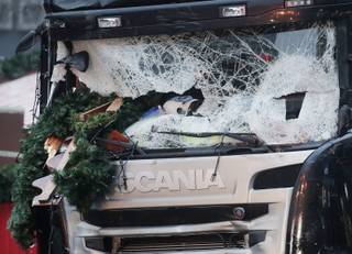 Christmas decoration sticks in the smashed window of the cabin of a truck which ran into a crowded Christmas market Monday evening killing several people in Berlin, Germany, Tuesday, Dec. 20, 2016. (AP Photo/Markus Schreiber)